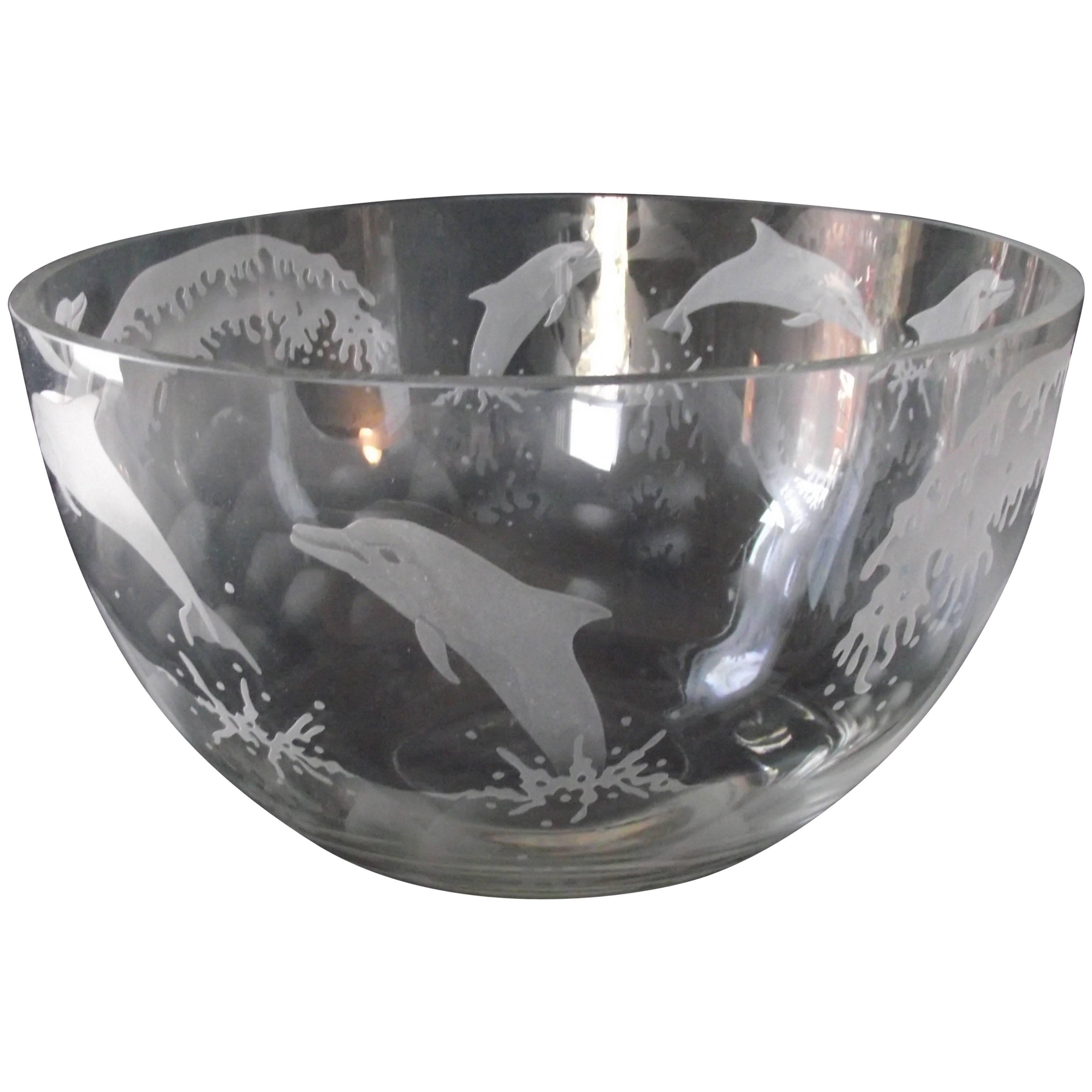 A truly unique piece, this large, heavy etched glass bowl is decorated with a school of Dauphins frolicking in the Ocean.

It is in extremely good shape no chips, bubbles or cracks. Very well executed. The bottom of the bowl bears the signature
