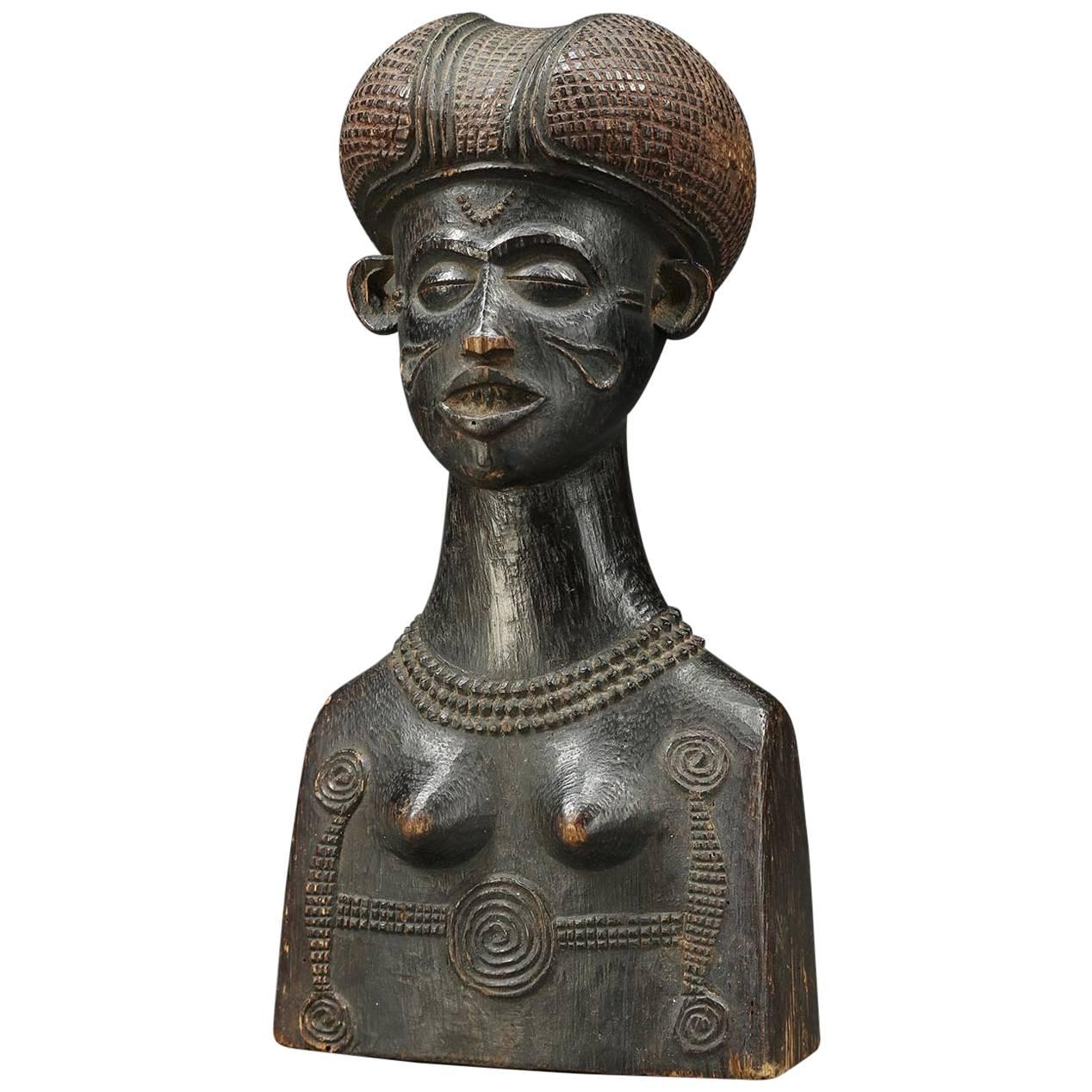 Early Chokwe finely carved wood bust, of a young woman with elaborate scarifications and Classic Chokwe hair style. Probably carved as a bust, sculptor's exhibition piece, early 20th century. Slight chips to nose and wear, 9 1/4