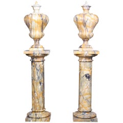 Pair of Vintage Grand Marble Urns on Column Plinths in the Neoclassical Style