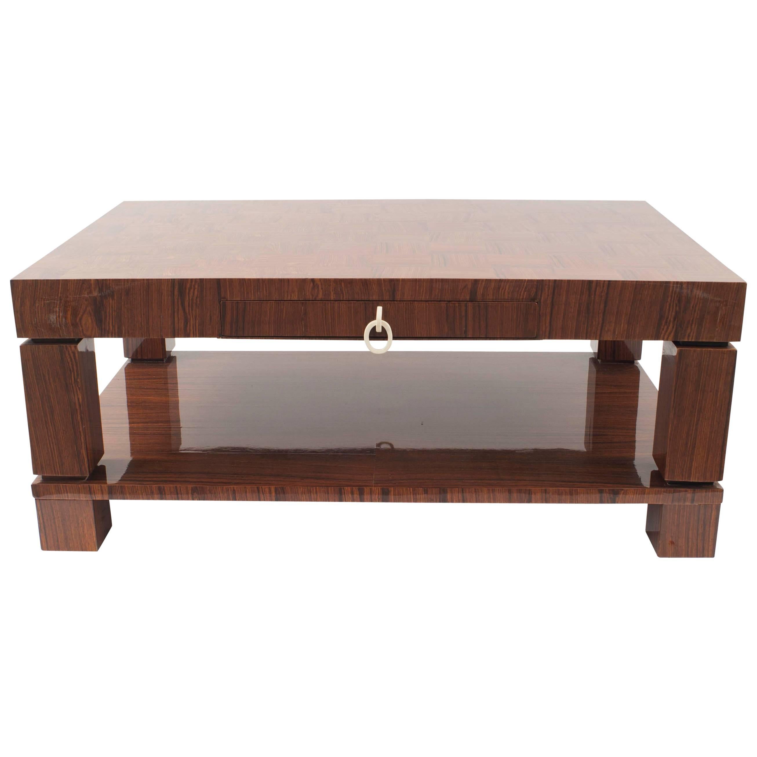 French Mid-Century (1950s) rectangular rosewood coffee table with square legs supporting a shelf and a checkerboard design top with two side drawers with a brass knob handles.
