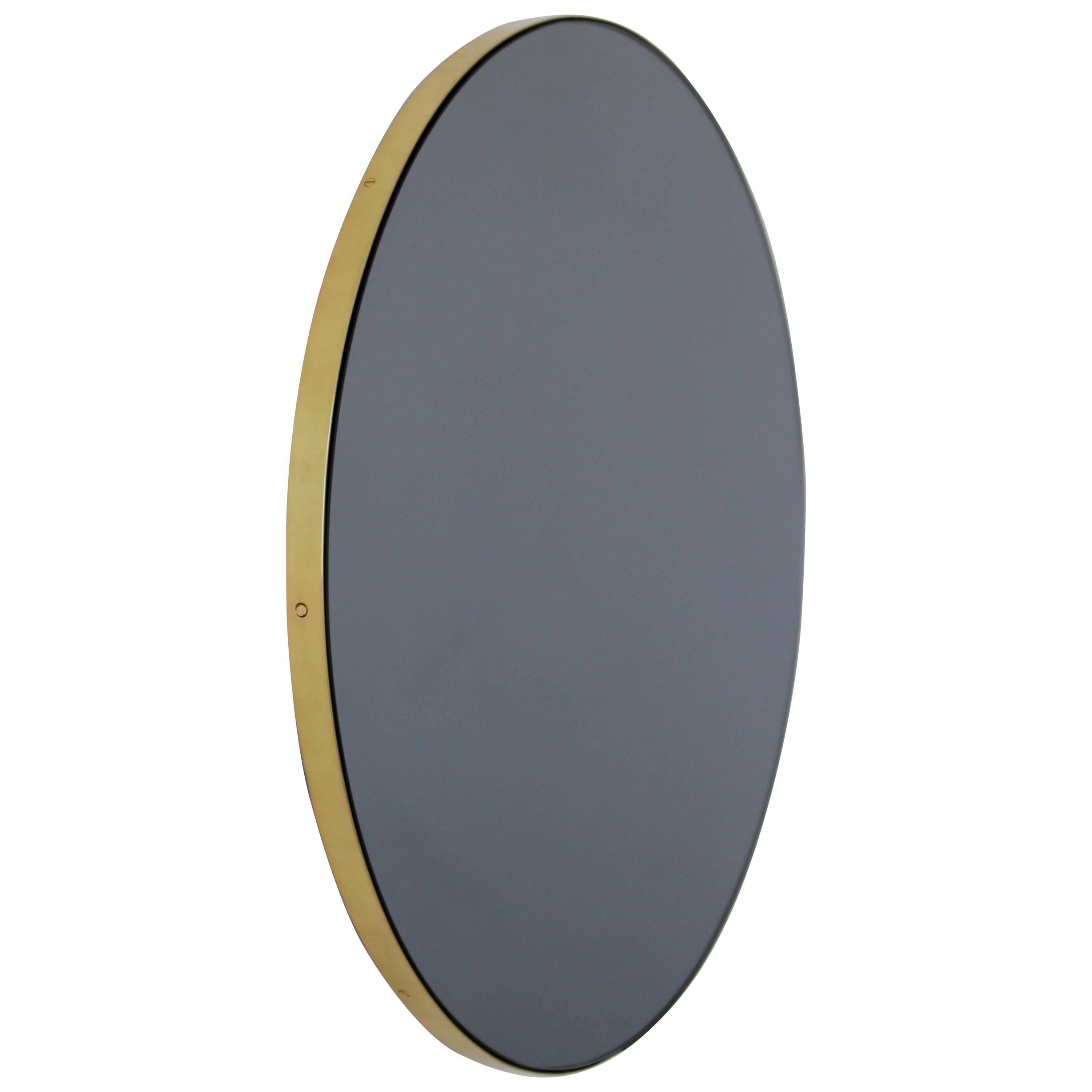 Orbis Black Tinted Round Contemporary Mirror with a Brass Frame, Medium For Sale
