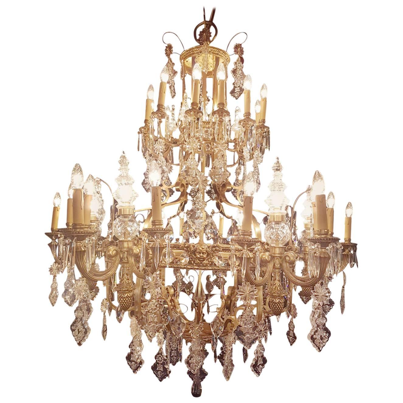 Beautiful and impressive large bronze cage chandelier with a total of 36-lights. In the top of this majestic chandelier are 12 candle lights combined with six pinnacles of glass. Six large bronze arms are carrying each three candle lights and one