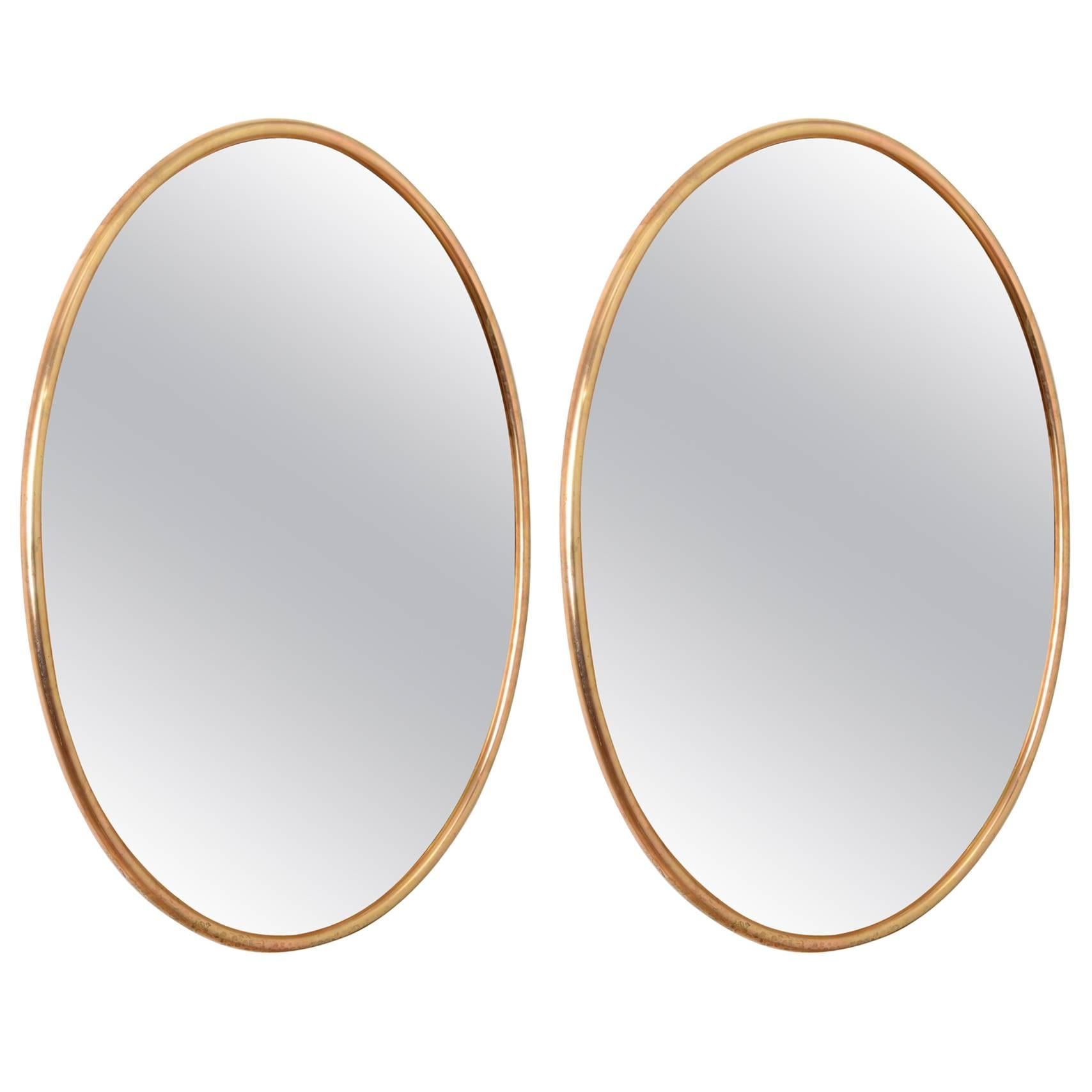 Two matched bronzed glass with brass frame mirrors c1969