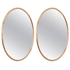 Two matched bronzed glass with brass frame mirrors c1969
