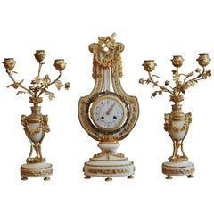 French Ormolu and White Marble Thee-Piece Lyre Shaped Clock Garniture