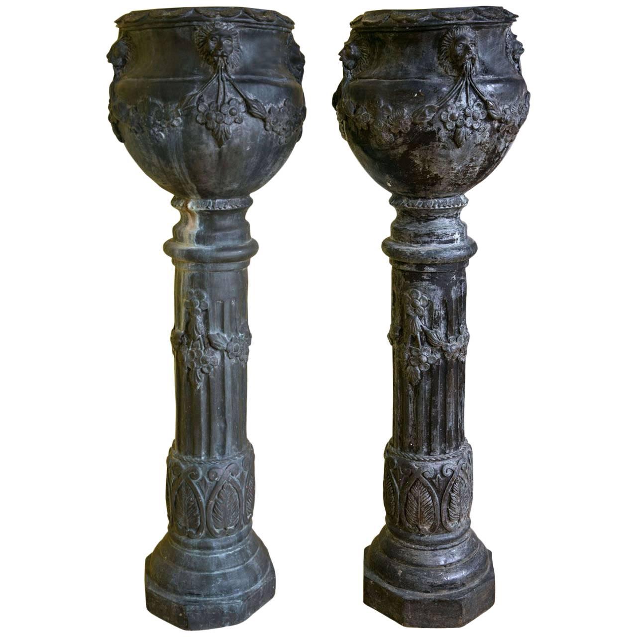 Pair of Metal Figural Garden Jardinieres on Pedestals