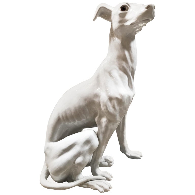 white ceramic greyhound statue