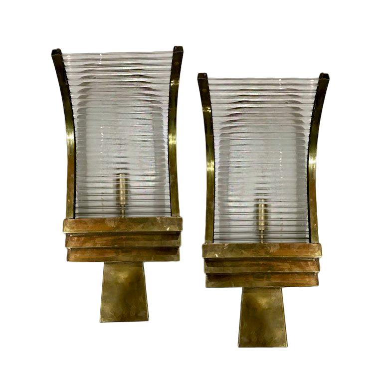 A set of four circa 1950s French bronze and glass rods sconces with an interior light.

Measurements:
Height 18.5