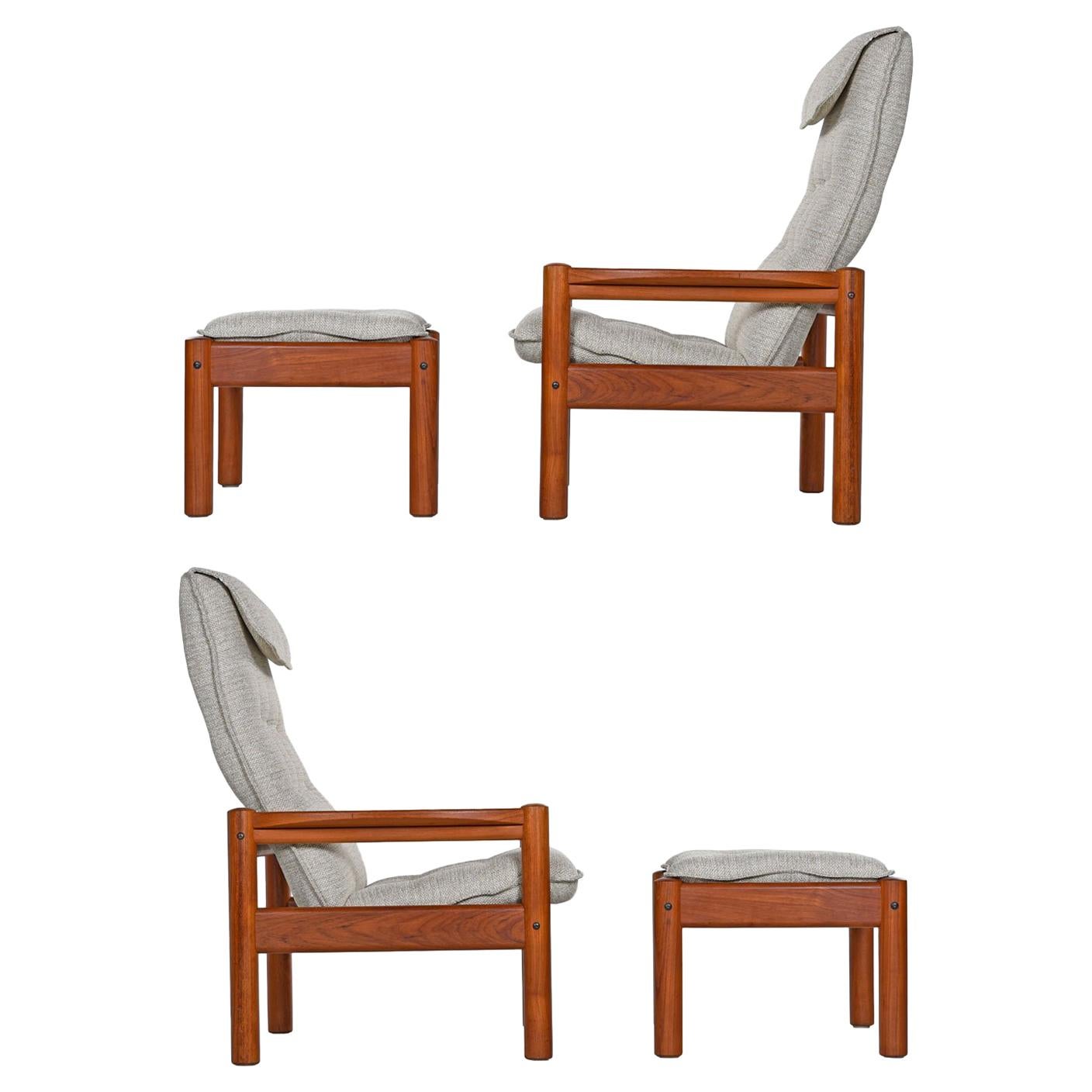Pair of Domino Mobler high back teak lounge chairs and matching ottomans restored to near mint condition. Solid teak frames with rigid construction. The sculpted arms stand out within the sleek, Minimalist, modern design. A perfect balance of