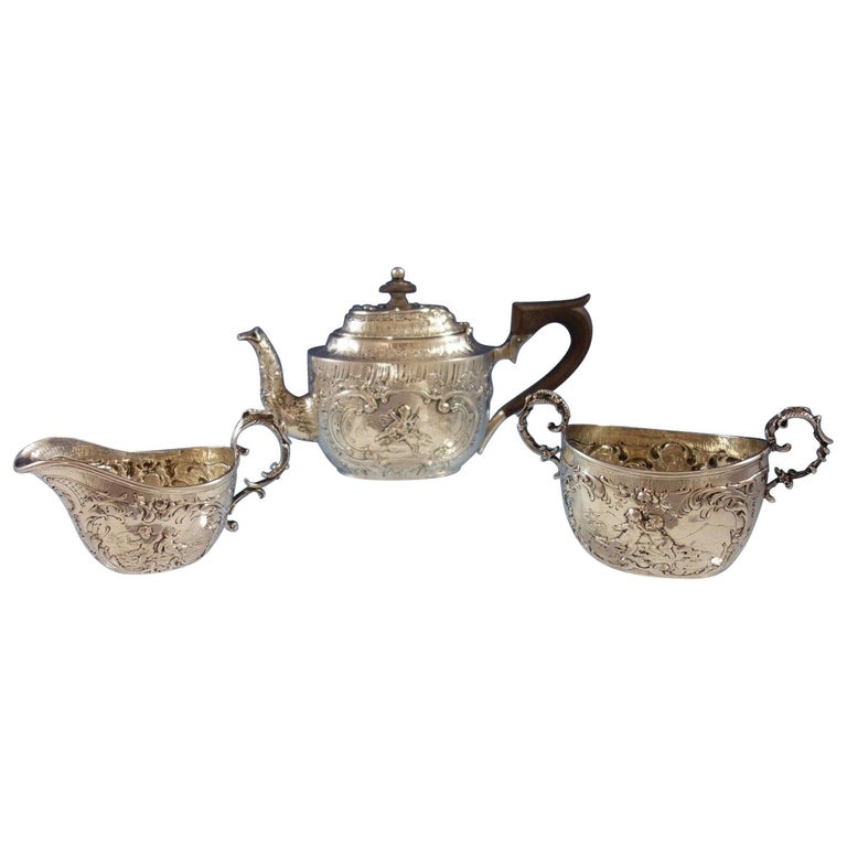 German, .800 Silver Tea Set of 3-Piece Figural Repoussed Cupids and Flowers For Sale