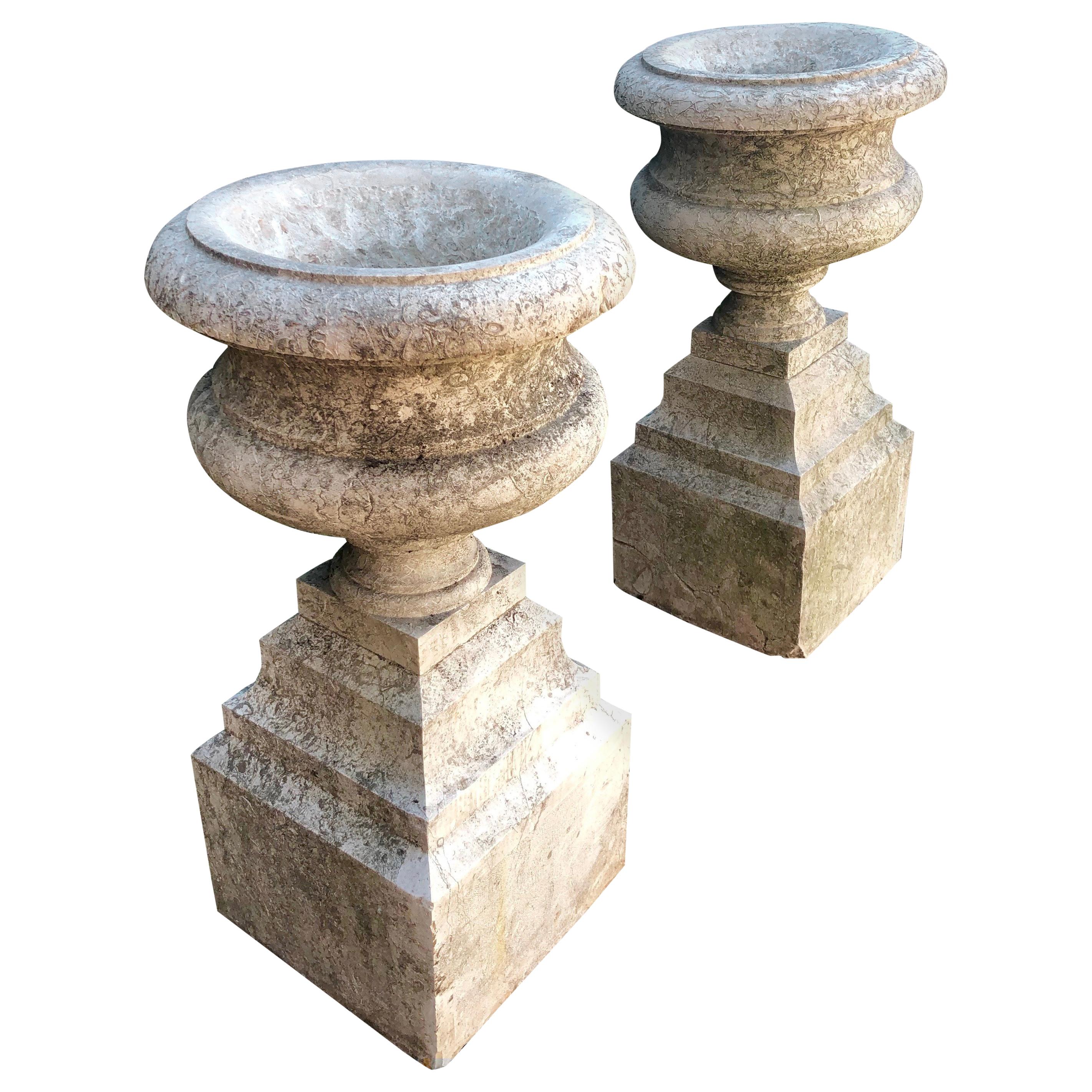 Pair of French "Pierre de Cassis" Tazza Urns on Integrated Plinths