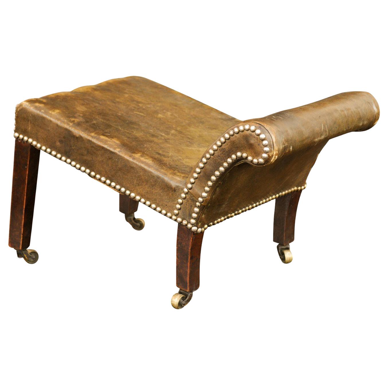 English 1920s Leather Gout Stool with Out-Scrolling Back, Nailheads and Casters