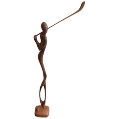 Sculpture d'un golfeur en bois