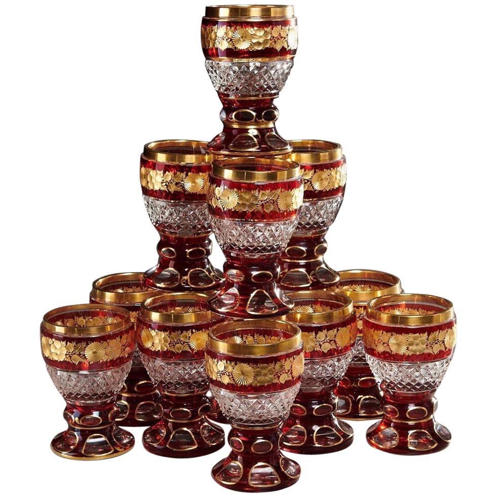 Set of 12 Ruby and Parcel-Gilt Bohemian Glasses, Late 19th Century For Sale