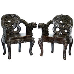 Antique Pair of Black Qing Dynasty Carved Dragon and Lion Foo Dogs Armchairs, circa 1870