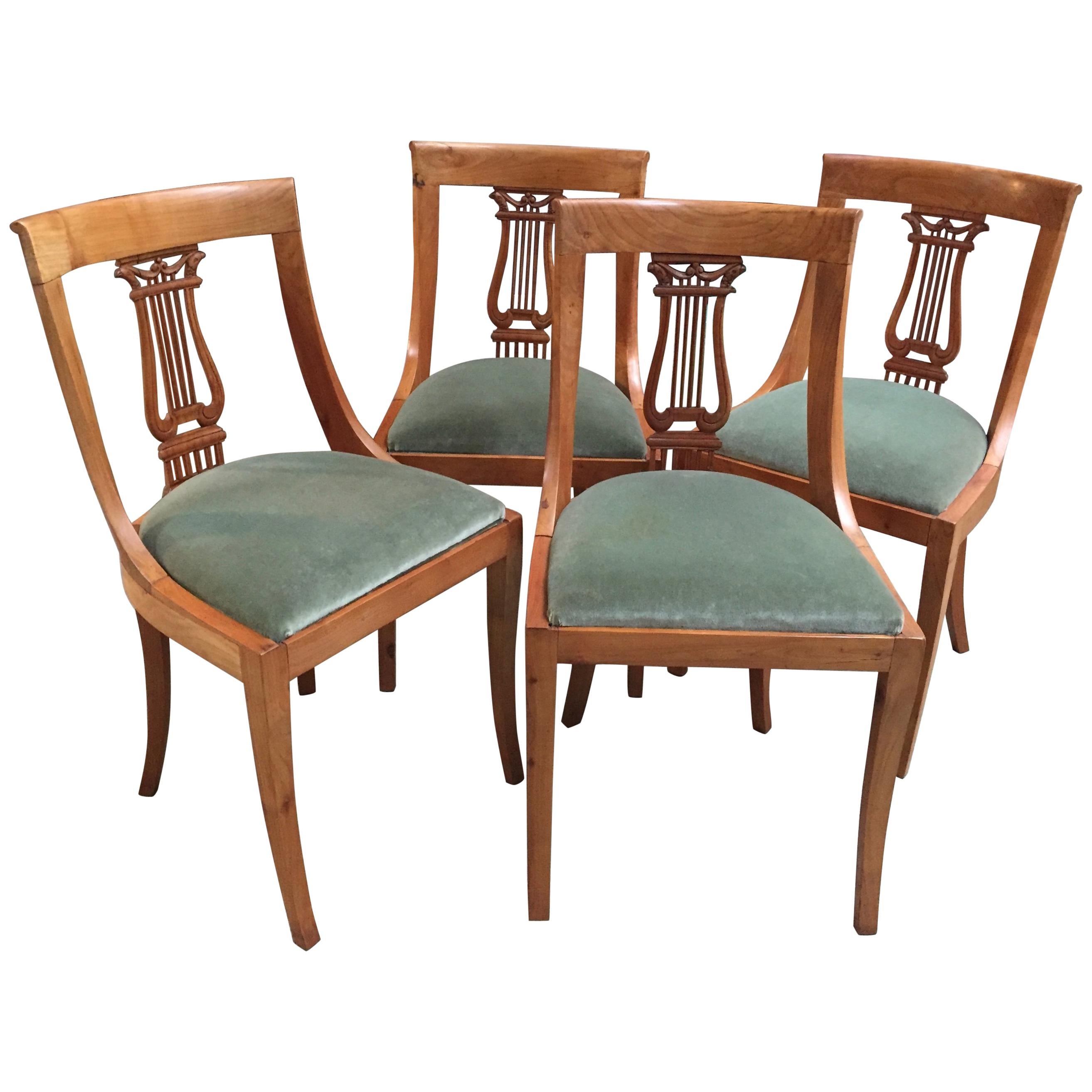 Set of Four French Neoclassical Fruitwood Lyre Back Chairs with Falcon Heads For Sale