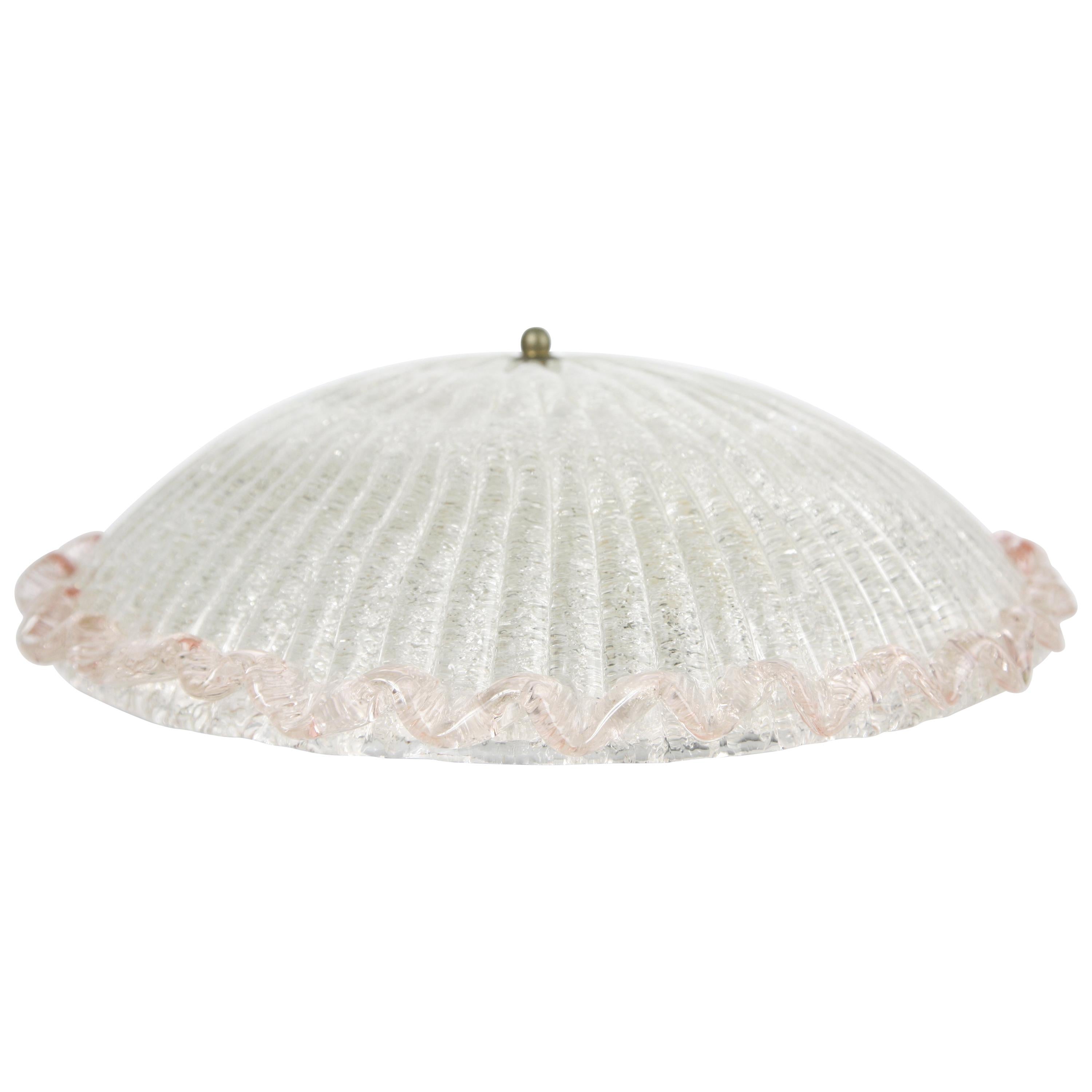 1950s Val Saint Lambert flush mount ceiling plate is white metal with 2 European sockets the shade is a dome shaped pressed glass that is clear with glass flakes on the inside of the dome which gives an effect in the glass the outer edge is pink