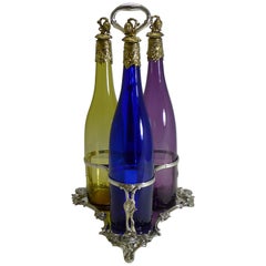 Three Victorian Coloured Glass Decanters in Stand, circa 1890