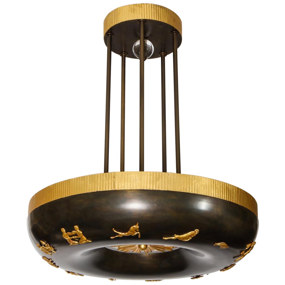 A new, Swedish Grace period inspired light by David Duncan. This pendant light features 12 cast bronze zodiac signs around the frame. The underside with frosted glass insert and a gorgeous cast bronze sunburst with gold leaf finish. This fixture