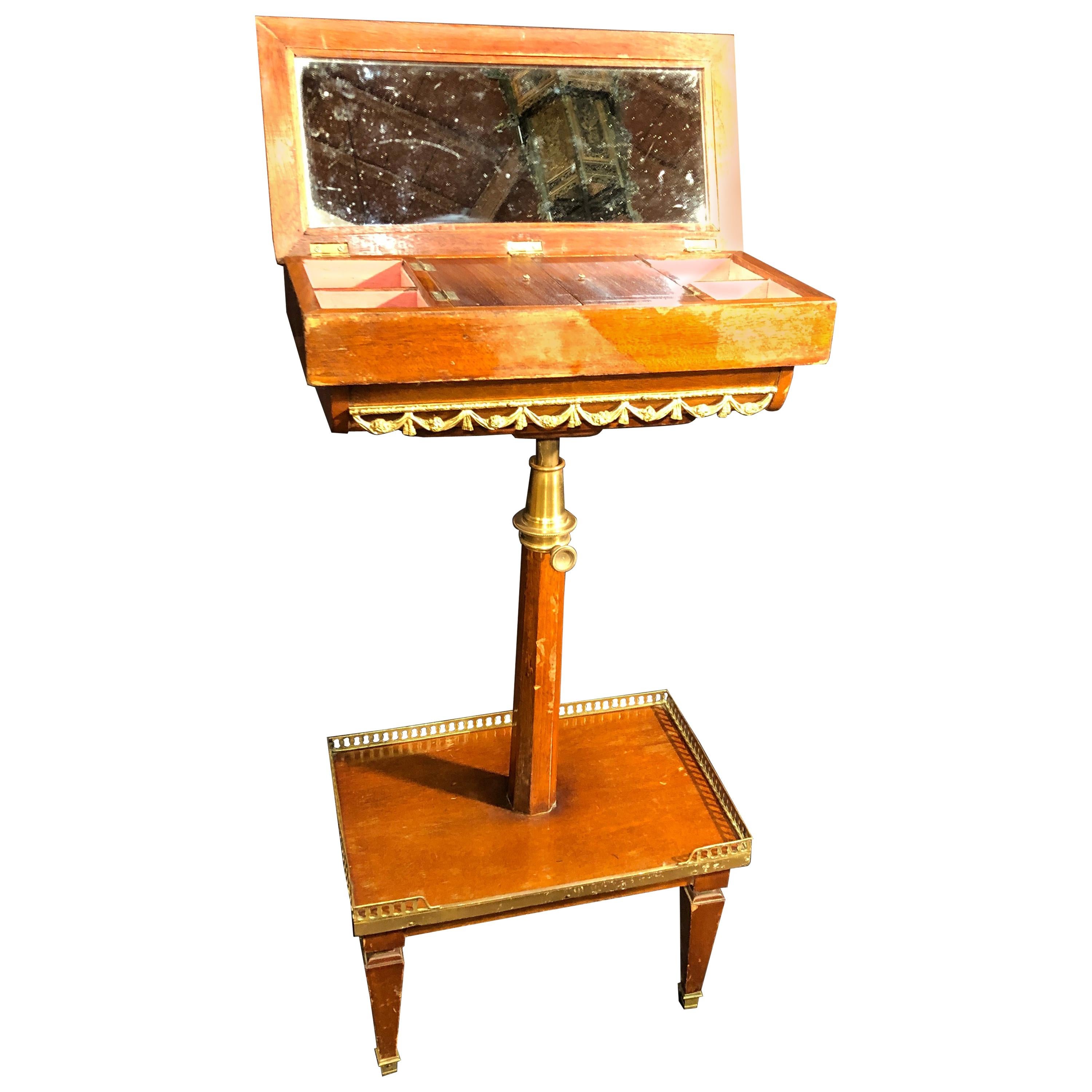 Nice ladies table, inside a well-finished dressing table with fabric and drawers, the central foot is adjustable to different heights. Solid mahogany and finished with golden bronze applications. Louis XVI style but later, late Napoleon III.
In