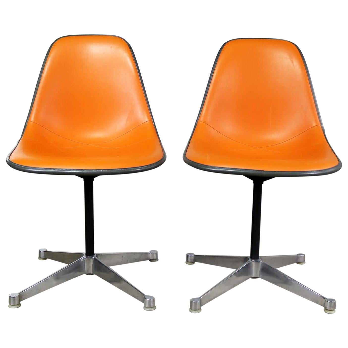 Pair of  Eames PSC Orange Vinyl Upholstered Pivoting Side Shell Chairs