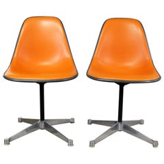 Retro Pair of  Eames PSC Orange Vinyl Upholstered Pivoting Side Shell Chairs