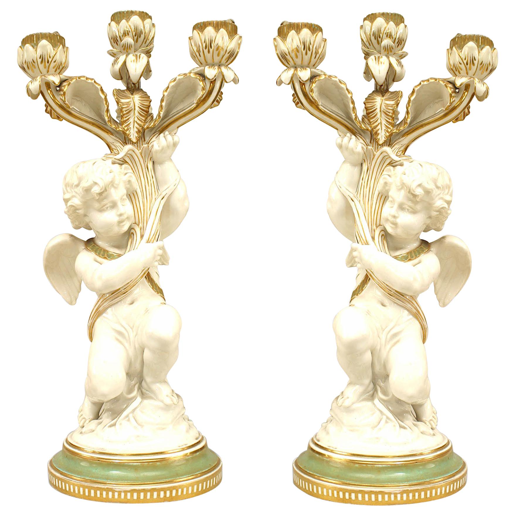 Pair of French Victorian White and Gilt Porcelain Cupid Candelabras For Sale