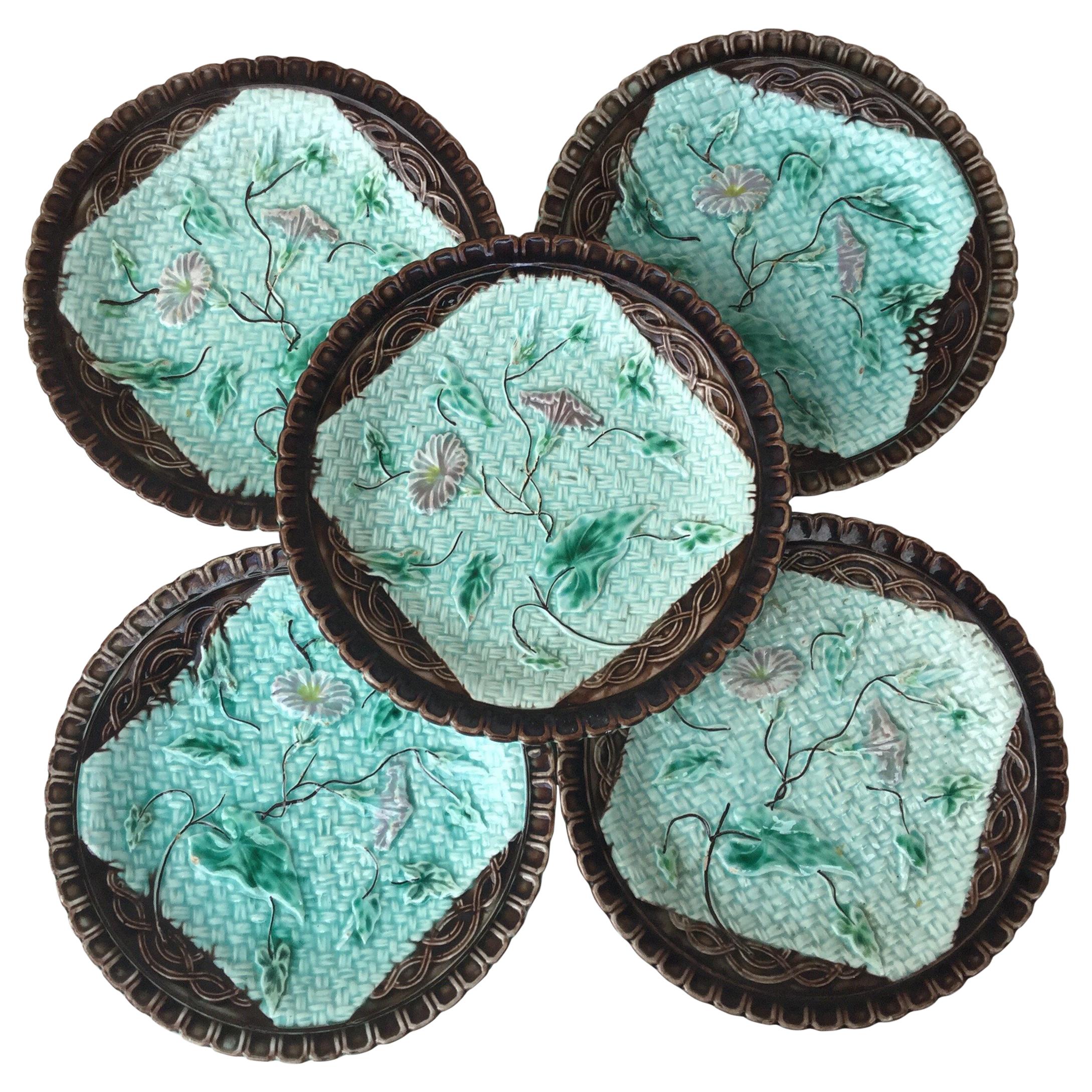 Set of 6 German Majolica plates with morning glory on a blue basket weave and a brown border, circa 1900.