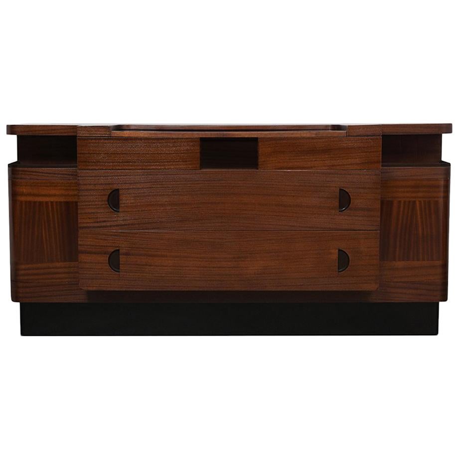 This sleek mid-century Italian credenza is stained in mahogany & black color combination with a newly lacquered finish and has been professionally restored by our team of in-house craftsmen. The sideboard features a pullout server shelf, two curved