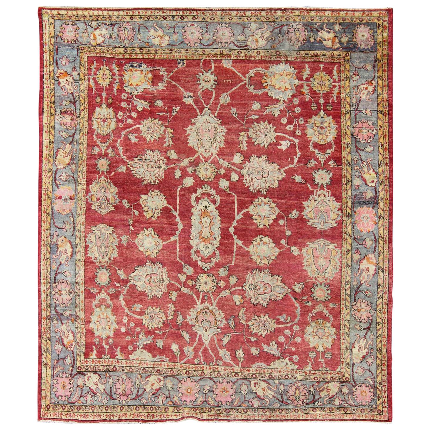 Antique Turkish Oushak Rug in Red, Blue/Gray Border, L. Green, Yellow & Pink For Sale