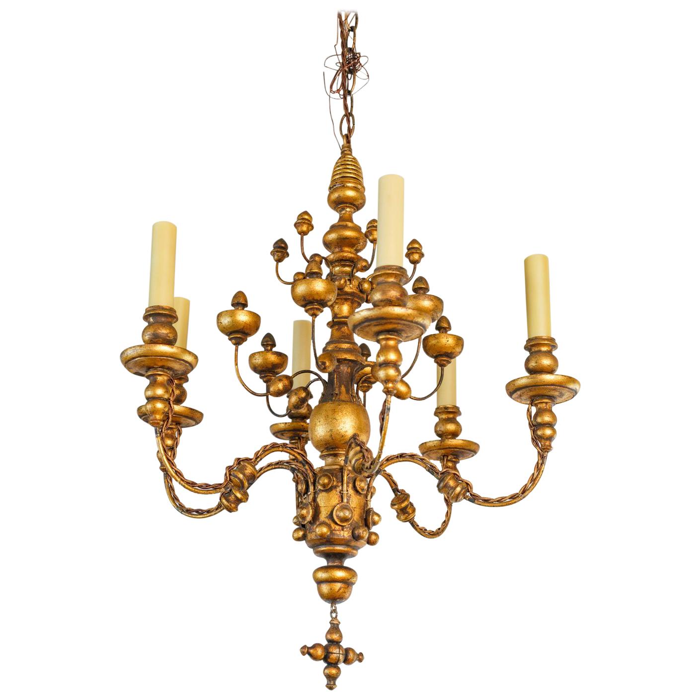Stunning Gilt  Italian Chandelier of Metal and Wood with  playful design.  For Sale