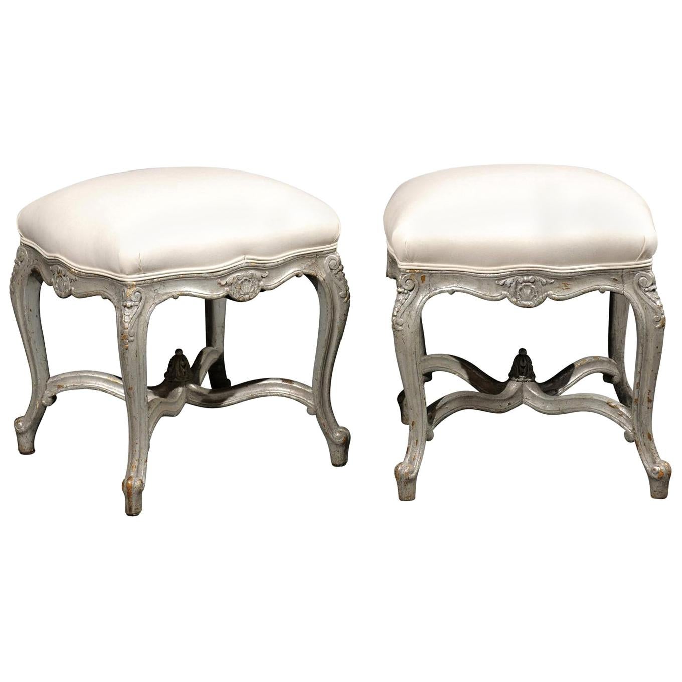 Pair of French Louis XV Style Silver Leaf Stools with Carved Cross Stretcher