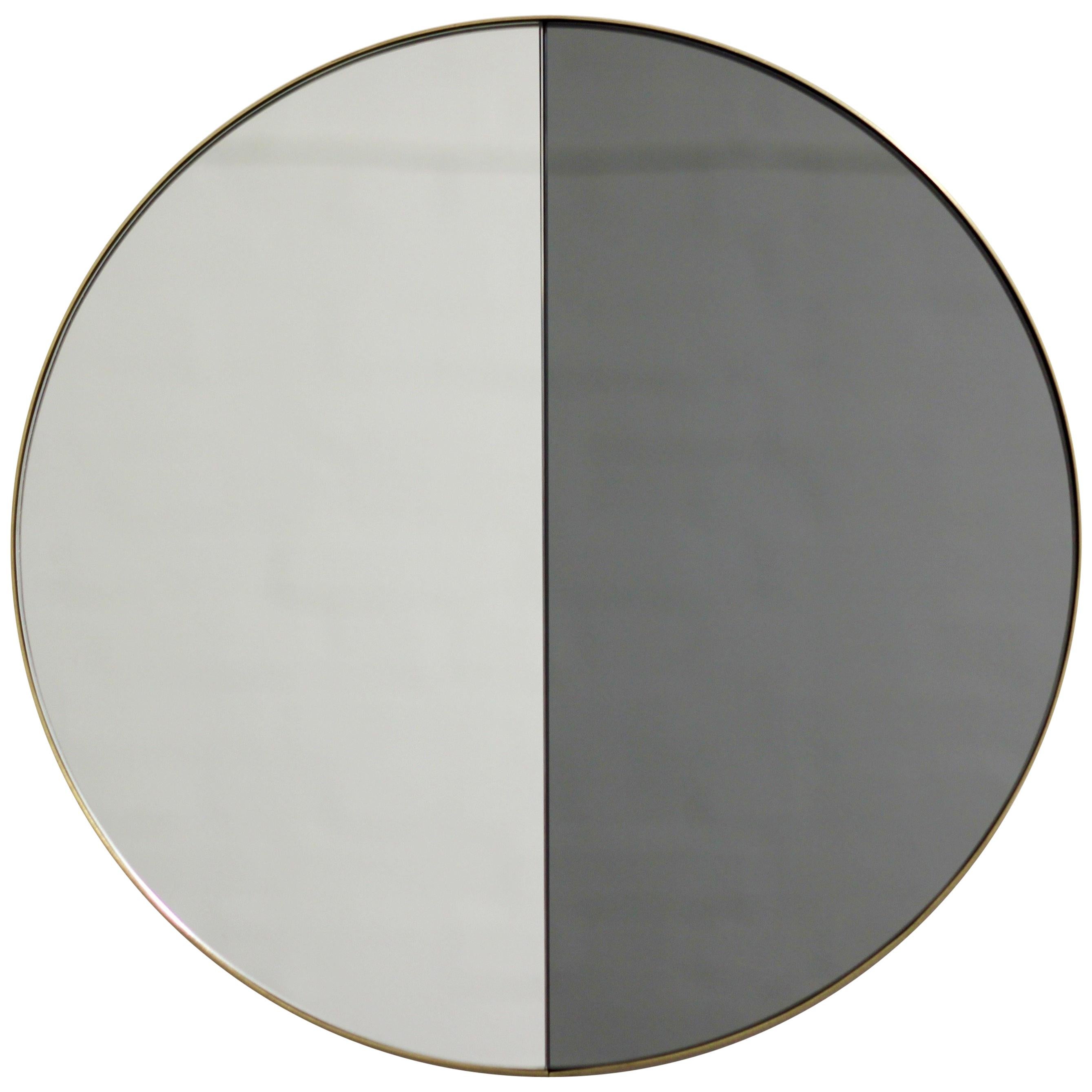 Contemporary mixed black and silver mirror tints Dualis Orbis with a brushed brass frame. Designed and handcrafted in London, UK.

Fitted with an ingenious French cleat (split batten) system so they may hang flush with the wall in four possible