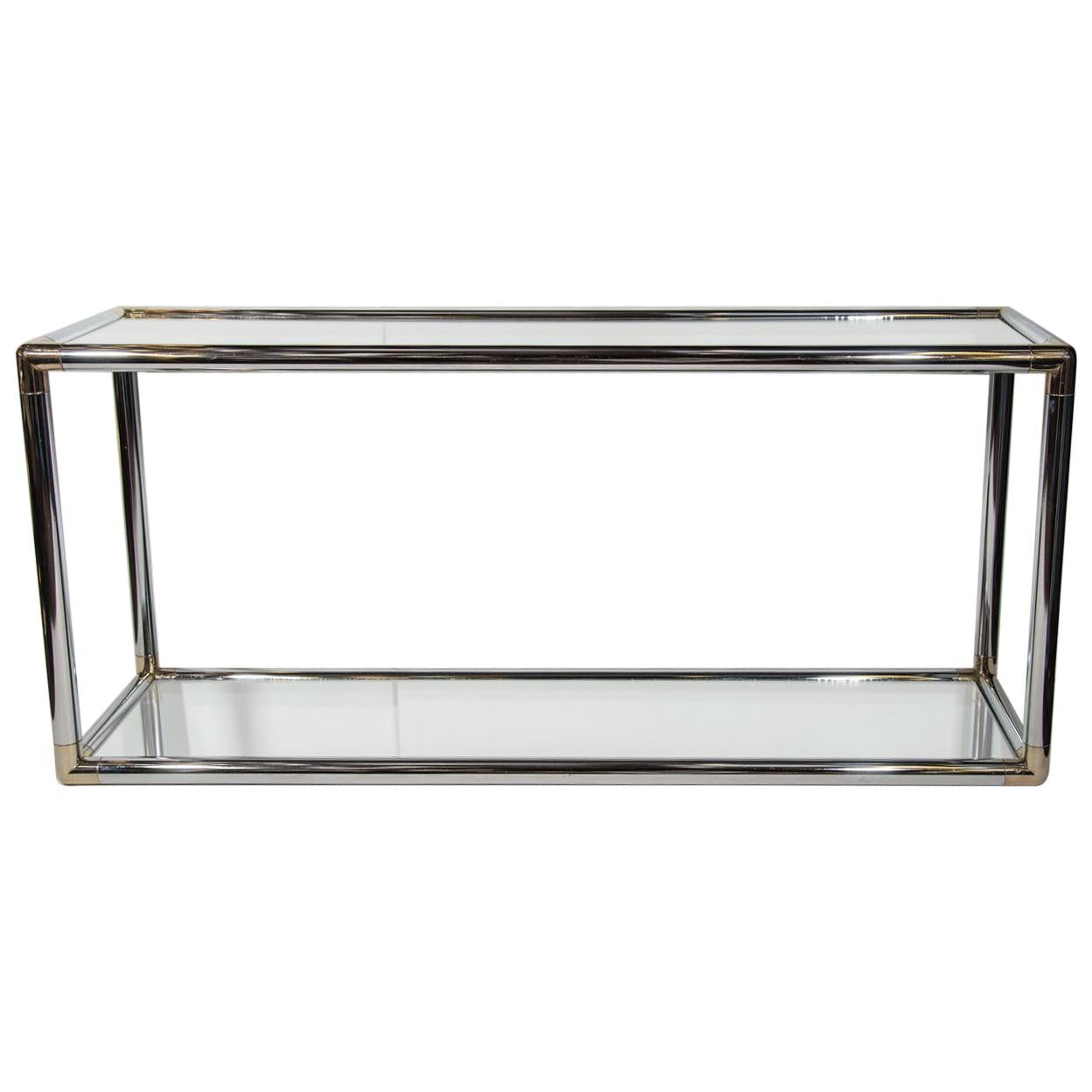 Italian Mid-Century Modern console table or sofa table with two-tier design. Comprised of tubular chrome frame with rounded brass corners, and fitted with mirrored tops. In the style of Romeo Rega.