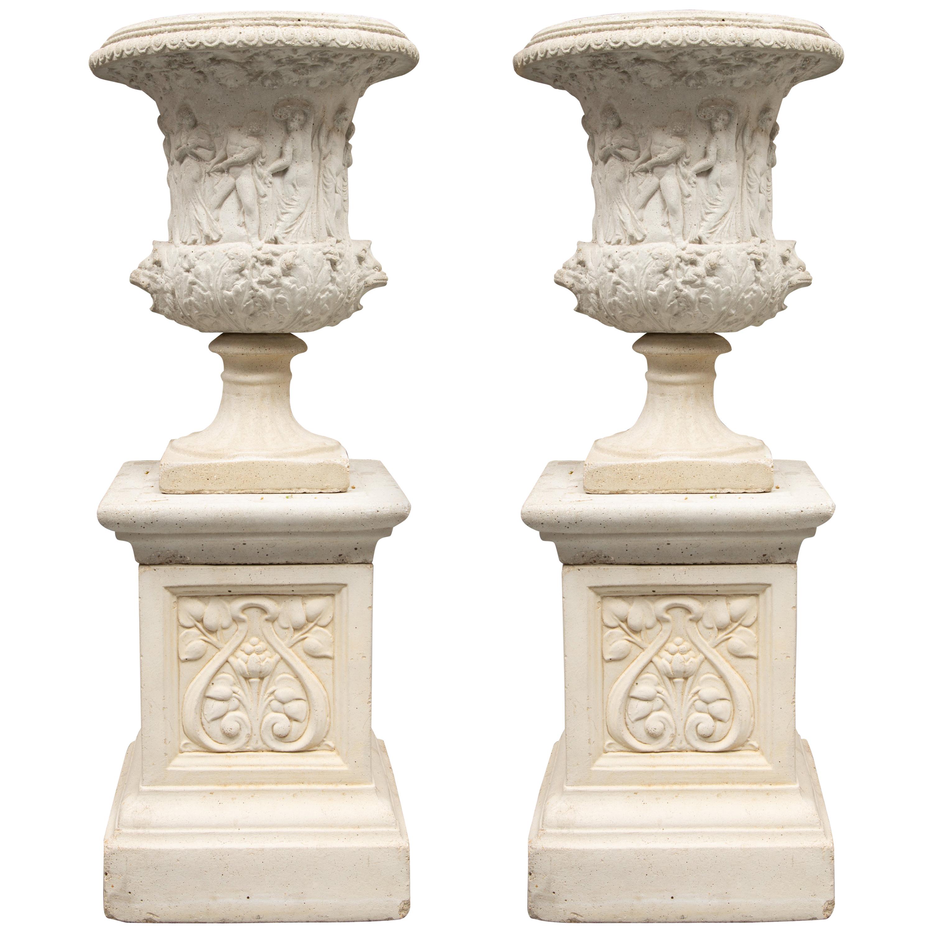 Pair of Cast Neoclassical Urns on Plinths