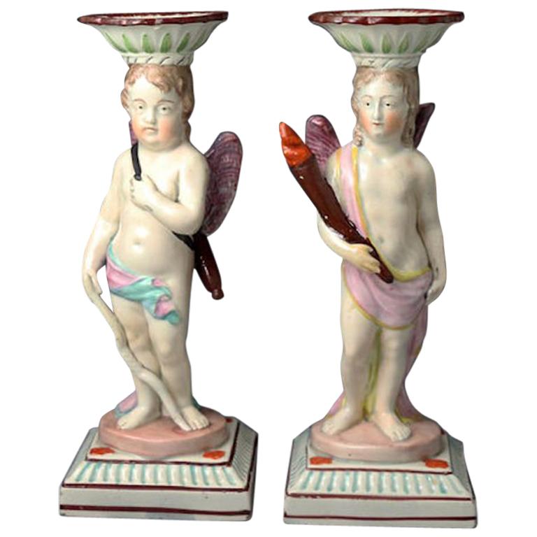 Antique Staffordshire Pottery Candlestick Figures of Cupid and a Putti For Sale