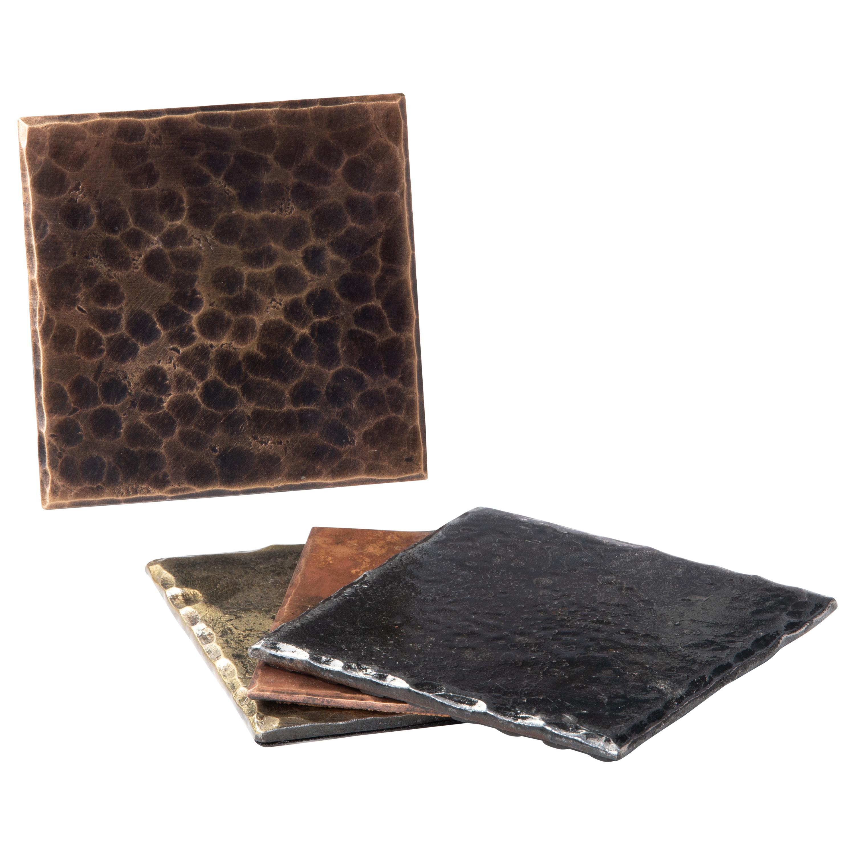 A handcrafted, square coaster made from planished bronze. The edges are hammered and beveled. Patinated and burnished to accentuate the forged details. A glossy clear coat enhances the richness of the finish and texture. Thin cork base. Sold as a