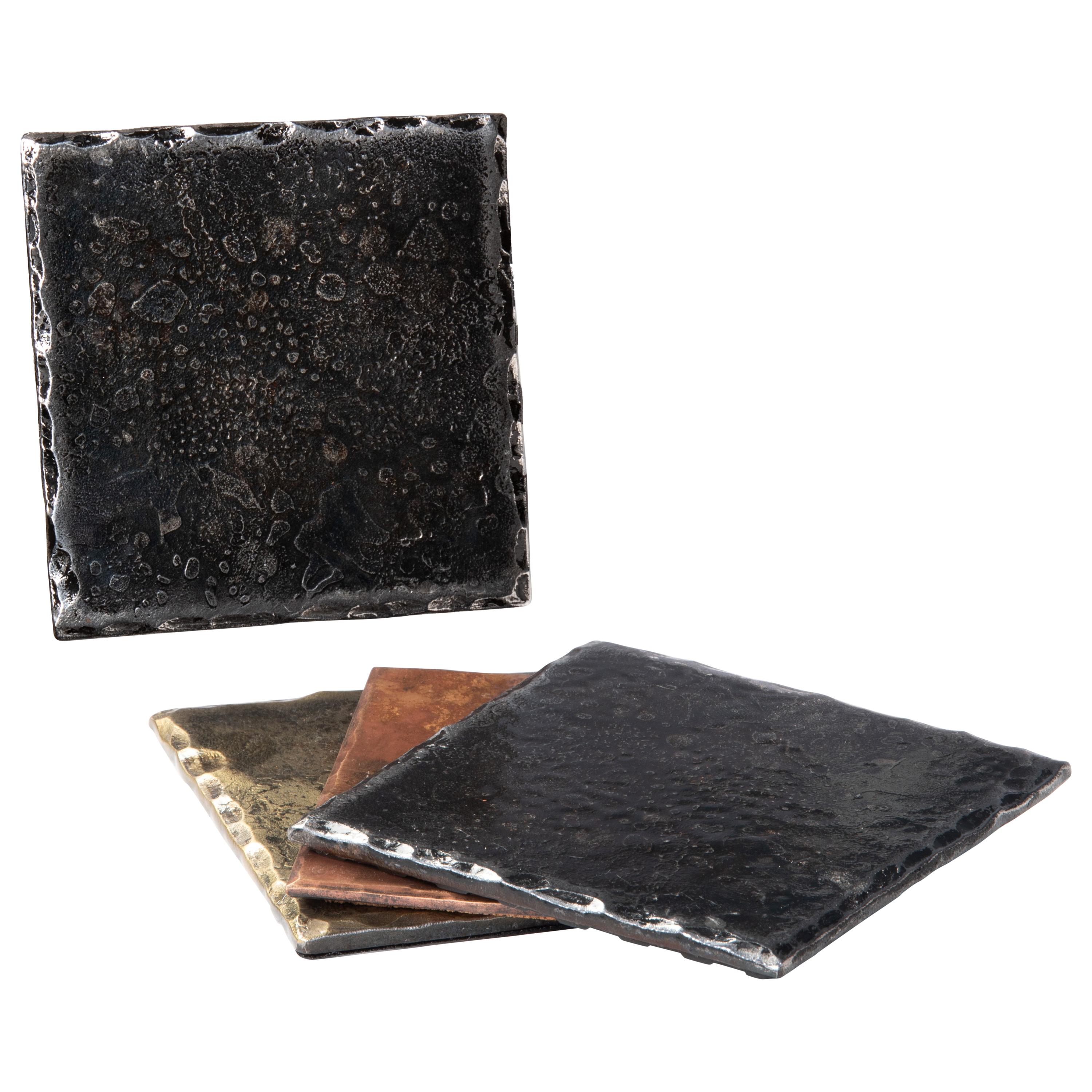 A handcrafted, forged, steel square coaster with hammered, bevelled edges that have been carefully polished. Wire brushed and lightly sanded to accentuate the contrast between the edges and the surface. A glossy clear coat enhances the richness of