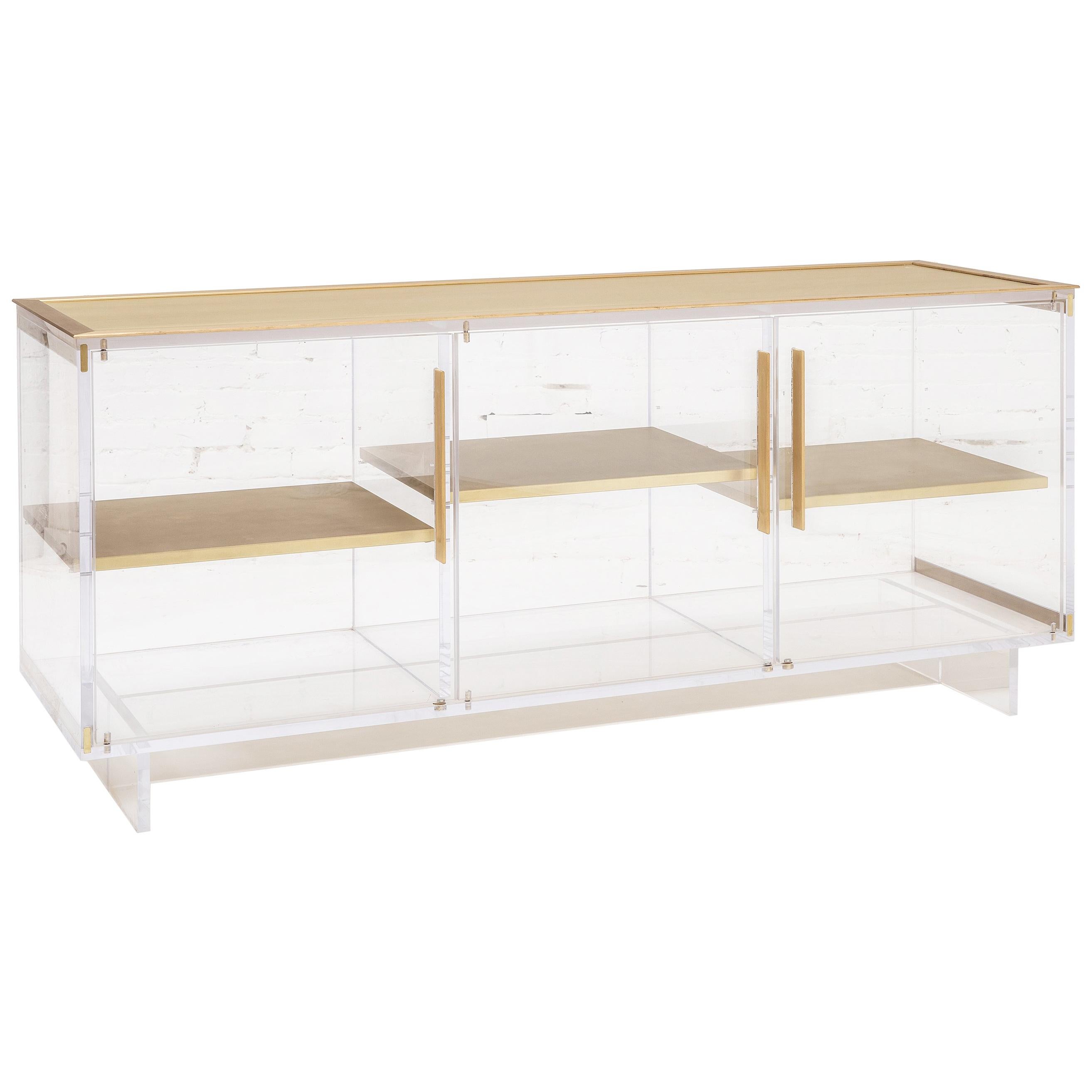 Custom Lucite sideboard with three adjustable brass shelves and brass top and pull handles by Reeve Schley.
