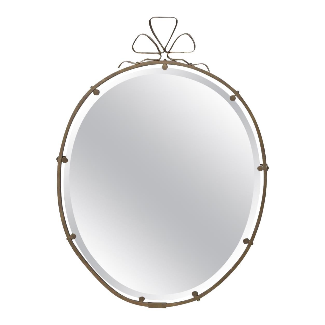 Charming and whimsical French brass mirror with ribbon design. 
