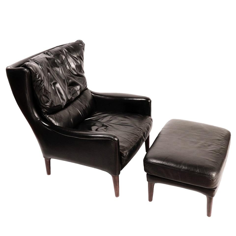 Danish Mid-Century Modern Black Leather Lounge Chair & Stool by Illum Wikkelsø For Sale