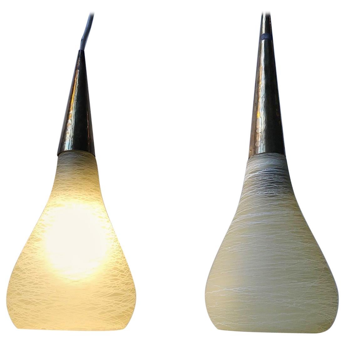 Unusual pair of Italian pendant lamps from the 1970s. The set is composed of organically shaped threaded glass shapes, topped with conical brass settings. The style is reminiscent of Stilnovo. The pendant has different heights of 34 and 39 cm.
