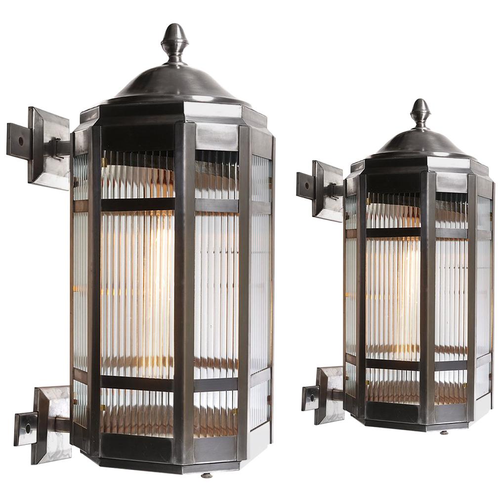 Pair of Large Stainless Steel and Ribbon Glass Sconces