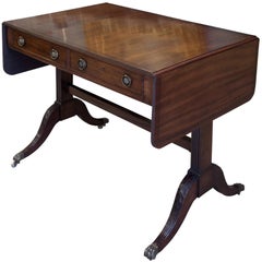 Antique 19thc Mahogany Sofa Table with carving to legs on brass castors