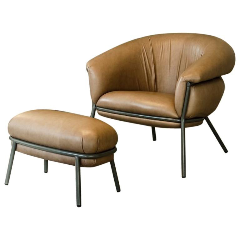 Armchair and footstool upholstered in leather and metal frame by Stephen Burks