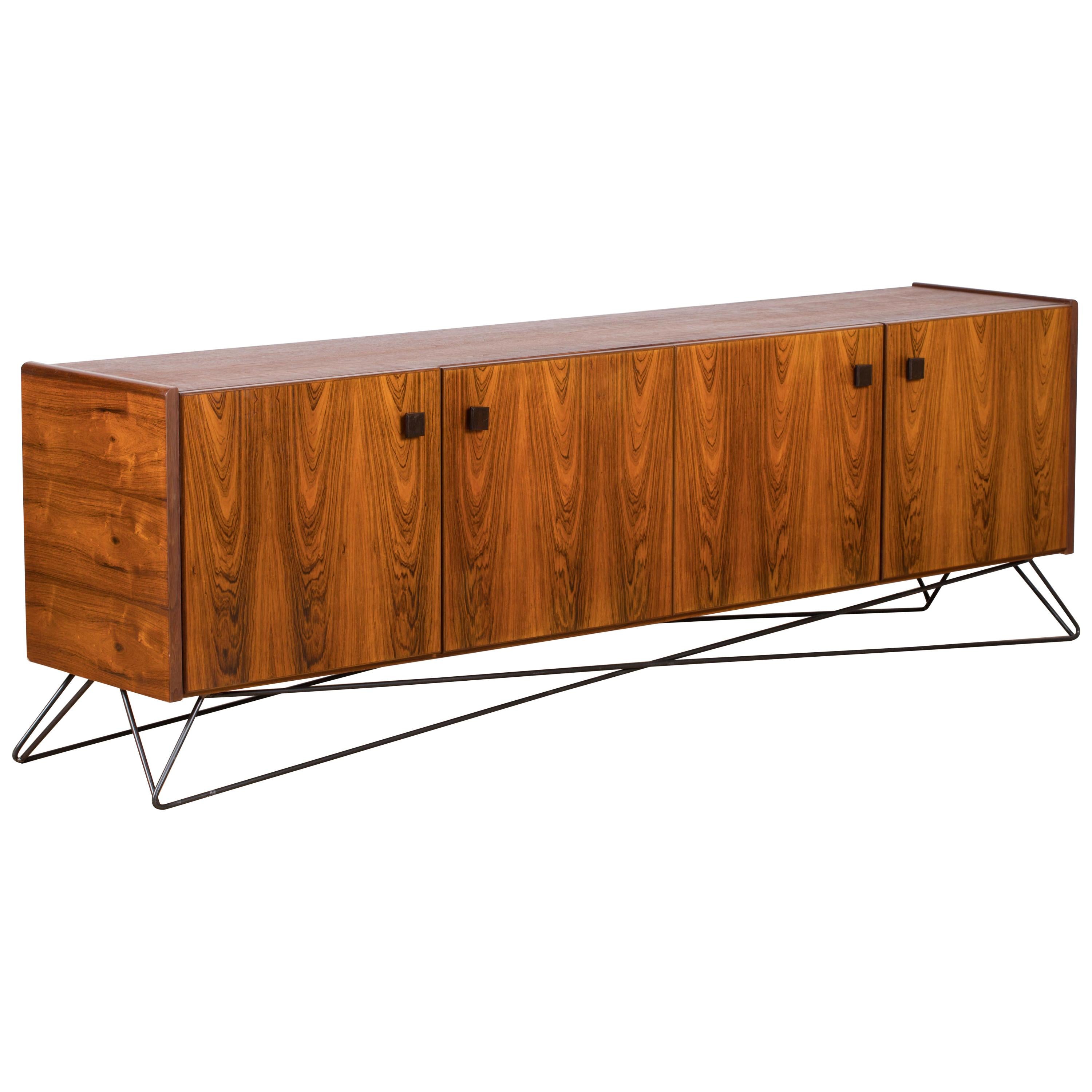 Midcentury walnut sideboard / Buffet from the 1960s. It is a shining example of the form and function synonymous with furniture of this era. It has is all, well-built, great design and heaviness. Two large storage spaces. The minimal design and the
