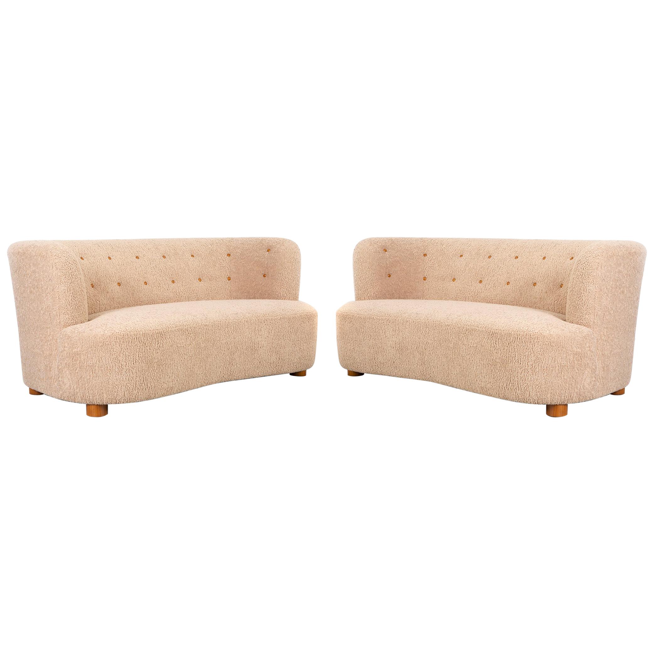 Set of two settees 

Denmark, circa 1960s

Freshly reupholstered in synthetic blend fabric with birch feet

Measures: 30 ?” H x 69 ½” W x 40” D x seat 18” H.

.