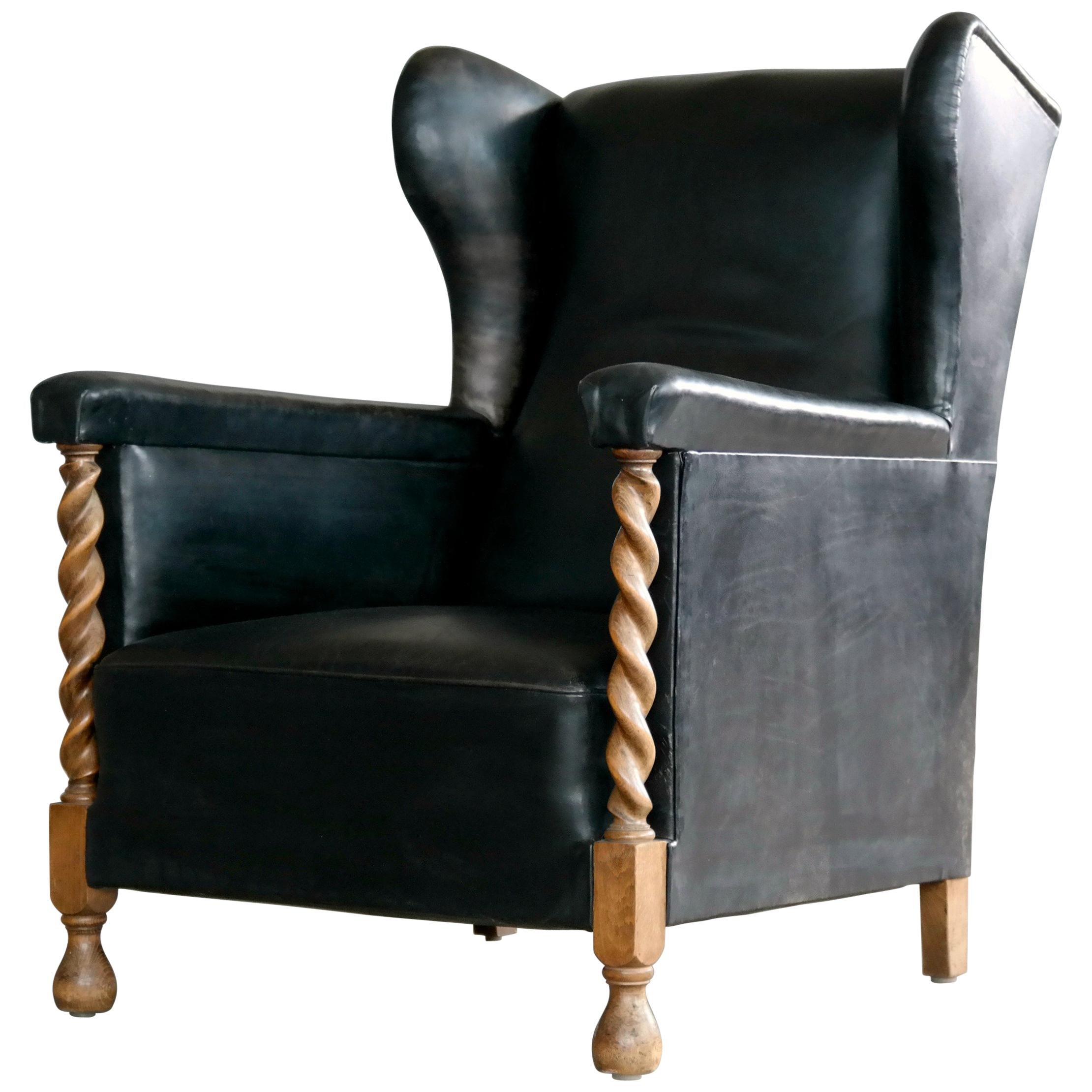 Danish 1930s Large Scale Club or Wingback Chair in Black Leather and Carved Oak