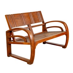 Vintage Teak Wood Settee from Madura with Folding Back, Looping Arms and Cane Seat