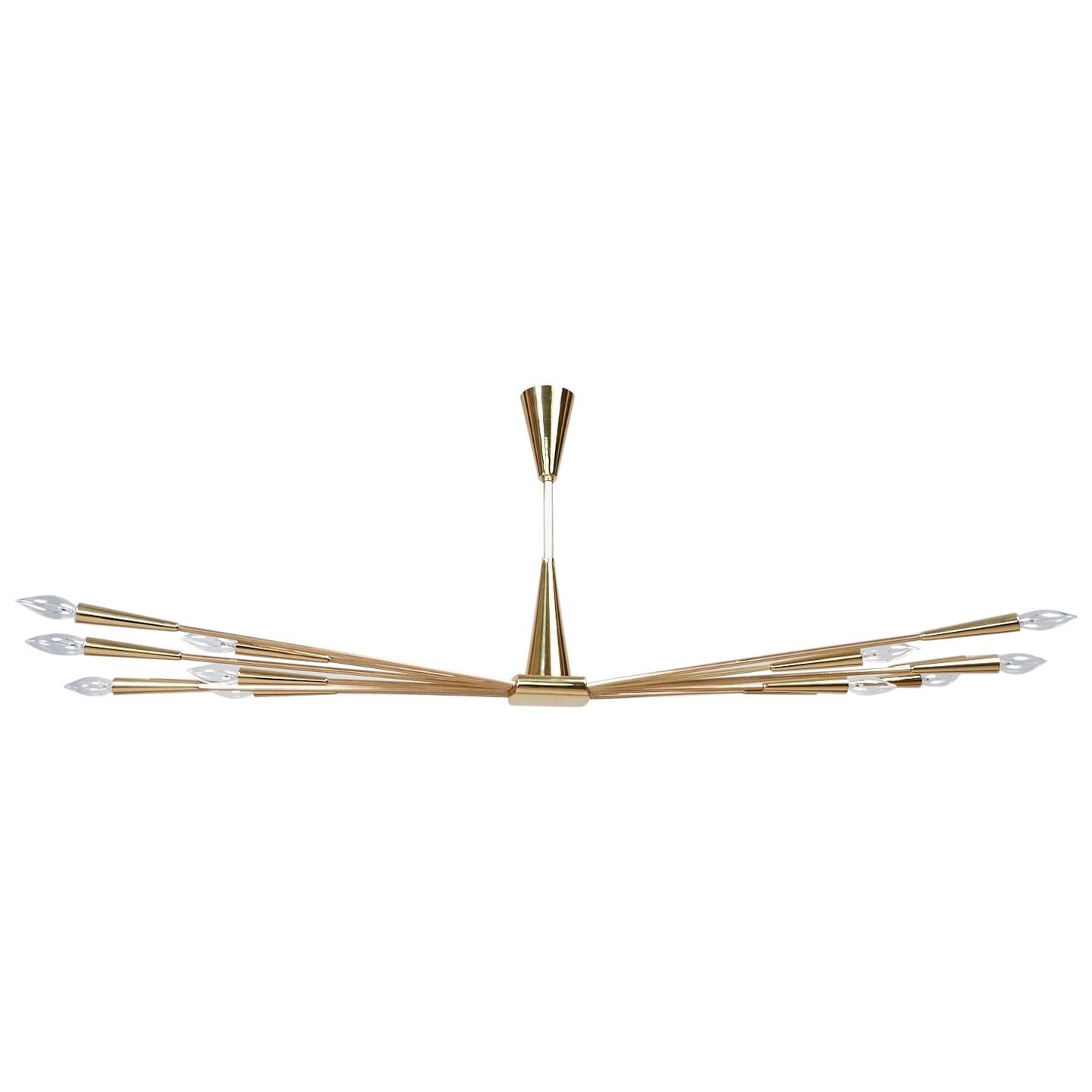 Oscar Torlasco (1934 - 2004) 

A stunning Sputnik chandelier by Oscar Torlasco in mirror-polished brass, with fourteen striated arms — alternating long and short — extending dramatically from a central rhombus with rounded edges, each culminating in